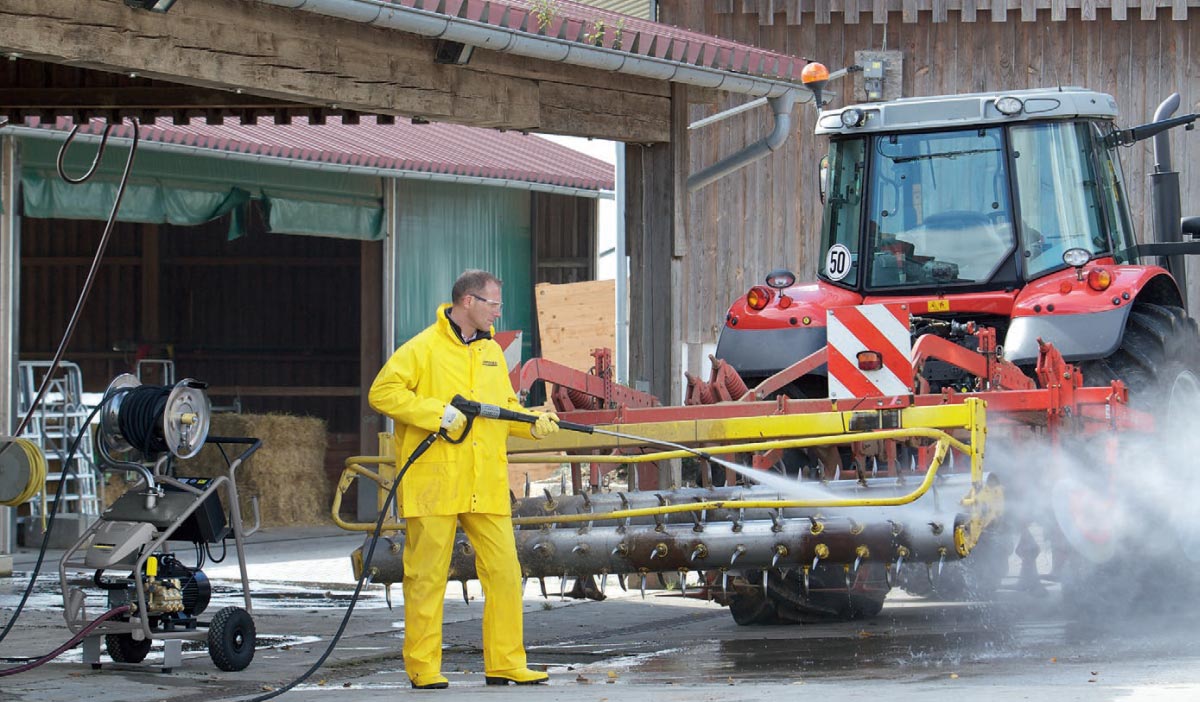 Profesjonalne ultra wysokociśnieniowe urządzenie HD 9/50-4 firmy Karcher Na zdjęciu profesjonalne ultra wysokociśnieniowe urządzenie HD 9/50-4 firmy Karcher dopsażone w opcjonalny bęben na wąż wysokociśnieniowy. Podczas mycia ciągnika rolniczego z wyposażeniem.